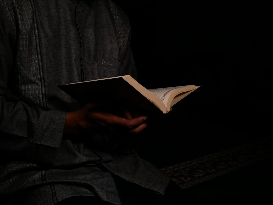 person reading mystery book at night